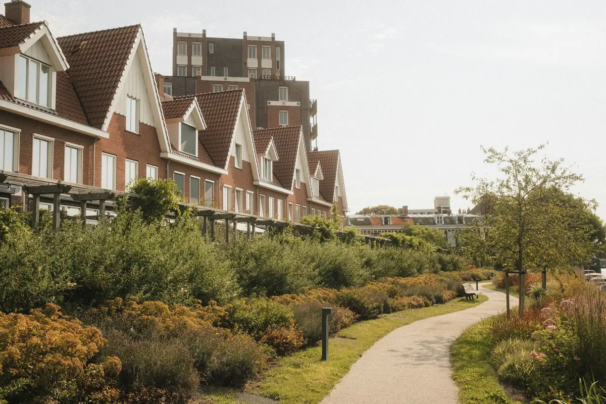 A row of brick townhouses behind a landscaped garden path