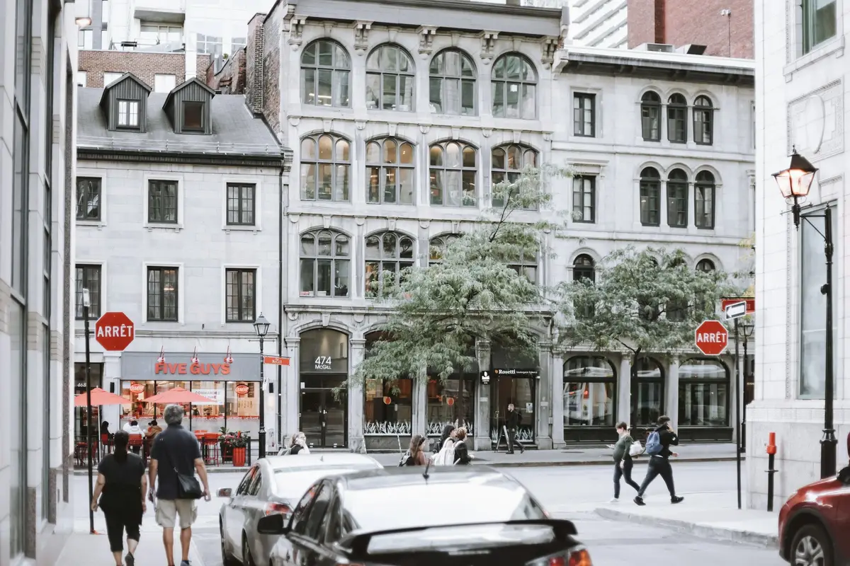 Pedestrians on a street of stone commercial buildings in Vieux-Montréal